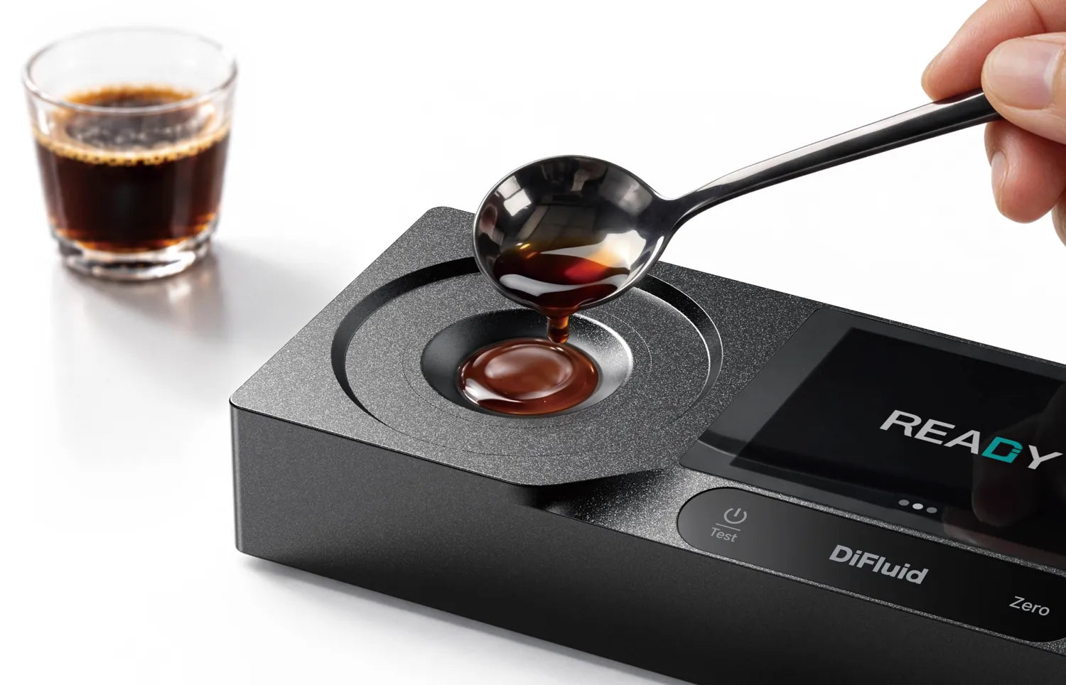 Espresso spooned into the sample well of RS Extract, READY on its screen