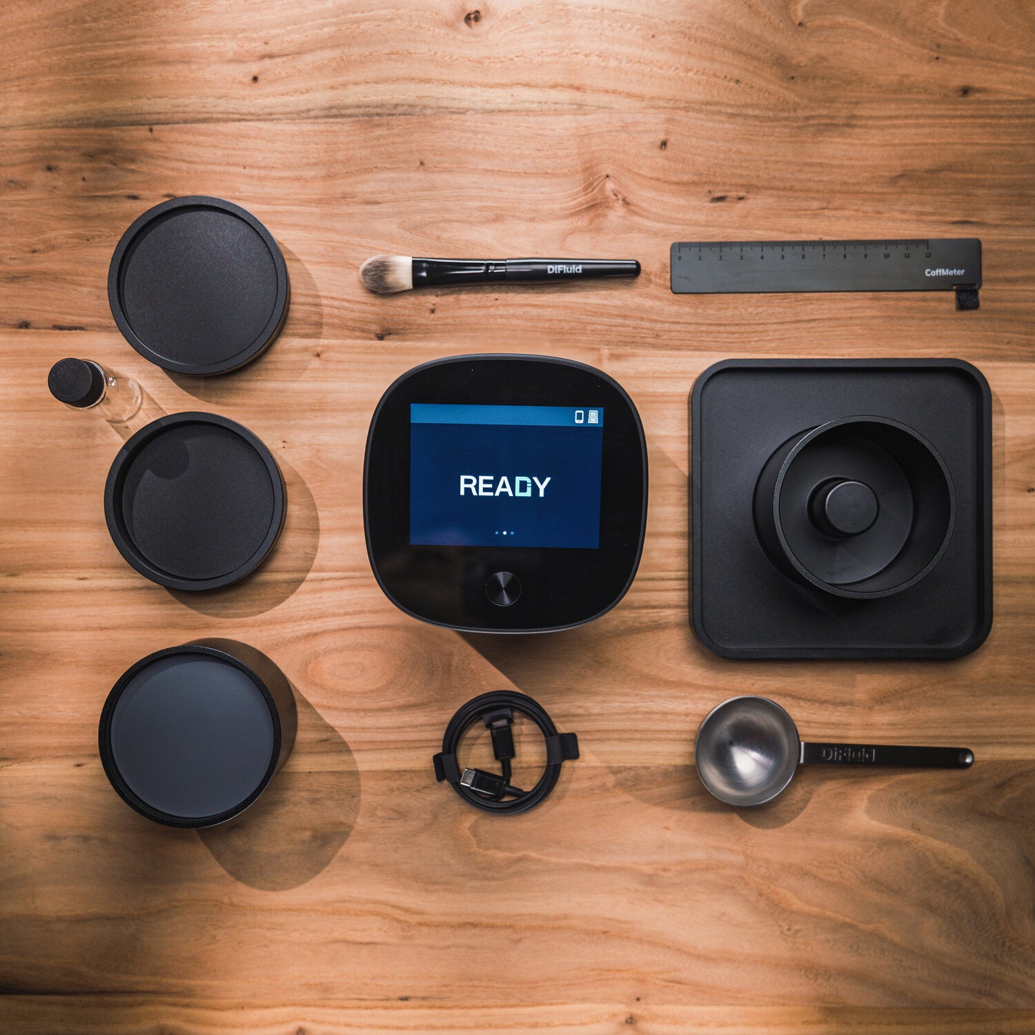 Omix Plus containers, bean sweeper, scoop and calibration tools laid out